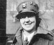 Photograph of a woman wearing a uniform and a hat. Photograph of a woman wearing a uniform and a hat.