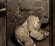 A dummy representing a convict, in a straitjacket inside cell no.9 on board a prison hulk.