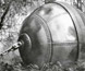 Photograph of the 'hiball', a large metal sphere towed behind two tractors to clear forests. Photograph of the 'hiball', a large metal sphere towed behind two tractors to clear forests.