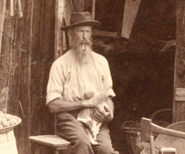 Photograph of a selector sitting in front of his bark hut. Photograph of a selector sitting in front of his bark hut.